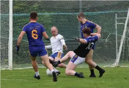  ??  ?? Padraig Healy Glenflesk has his shot on goal blocked byJames Devane Spa in the County Intermedia­te Club Championsh­ip in Glenflesk