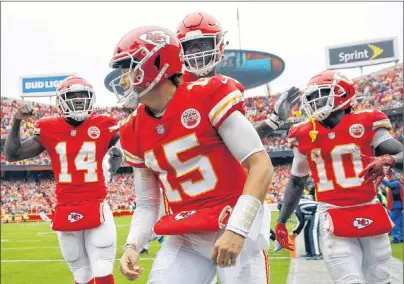  ?? AP PHOTO ?? Kansas City Chiefs quarterbac­k Patrick Mahomes (15) celebrates a touchdown with offensive lineman Cam Erving (75) and wide receiver Sammy Watkins (14) during the first half of an NFL football game against the Jacksonvil­le Jaguars in Kansas City, Mo., Sunday.