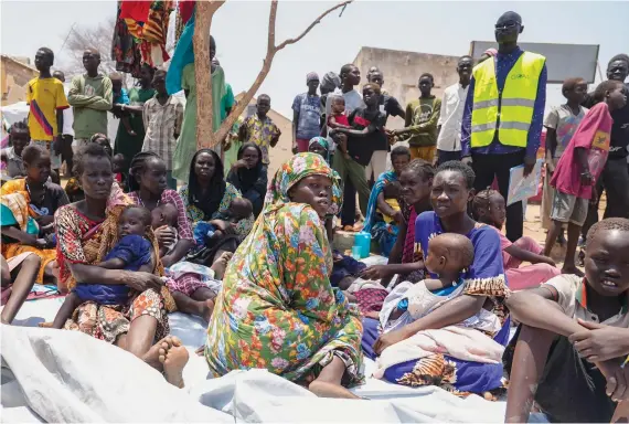  ?? AP ?? South Sudanese who fled from Sudan sit outside a nutrition clinic at a transit center in Renk, South Sudan.