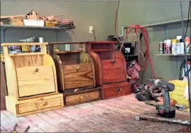  ?? / Liz Crumbly ?? A set of cash registers in different colors awaits buyers in woodworker Ben Early’s shop.