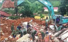  ?? PROVIDED TO CHINA DAILY ?? Rescuers search a military base on Sunday in Vietnam’s Quang Tri Province after a mudslide buried 22 soldiers.