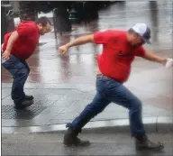  ??  ?? Utility workers play in the winds of Hurricane Ida as they wait for it to pass to begin repairs in New Orleans, Louisiana