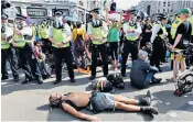  ?? ?? Zealots: An Extinction Rebellion protester blocks the road in central London