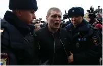  ?? (Maxim Shemetov/Reuters) ?? POLICE OFFICERS DETAIN a man while patrolling central Moscow during an antigovern­ment protest yesterday.