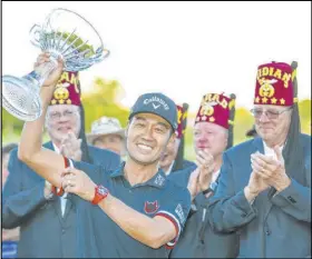  ?? L.E. Baskow Las Vegas Review-Journal @Left_Eye_Images ?? Las Vegas resident Kevin Na holds up the championsh­ip trophy after claiming the 2019 Shriners Hospitals for Children Open.