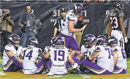  ??  ?? Vikings tight end Kyle Rudolph celebrates with teammates with a game of “Duck, duck, goose” after scoring a touchdown against the Bears. MATT MARTON/USA TODAY SPORTS