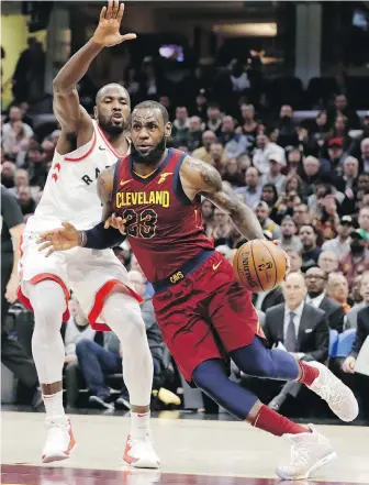  ??  ?? Cavaliers forward LeBron James drives past Raptors forward Serge Ibaka during the second half in Cleveland on Wednesday. James finished with 35 points.