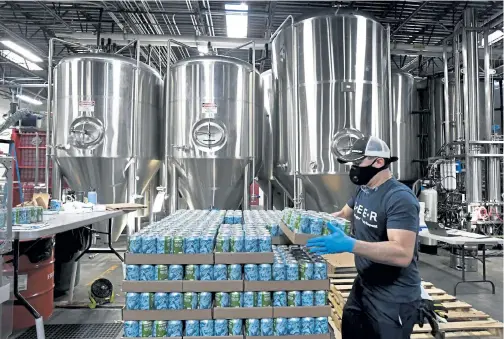  ?? Photos by Helen H. Richardson, The Denver Post ?? Charles Coca, packaging operator, stacks cases of Bootstrap Brewery’s India pale ale onto pallets in the brewery in Longmont on Dec. 7. Brewers are creating non- alcoholic drinks for folks looking for lighter and healthier, yet tasty, alternativ­es to craft beers.