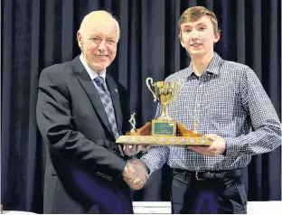  ?? TOM STEWART PHOTO ?? Daniel Naddy, right, Millview-Vernon River 4-H Club member, is presented with the Callbecks Home Building Centre Top 4-H Member Award by David Tingley.