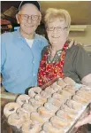  ??  ?? Jim and Muriel Erickson show off apple-cider doughnuts at their orchard store in Bayfield, Wis. Bayfield’s apple fest runs Oct. 2 to 4.