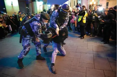  ?? (AP Photo, File) ?? Riot police detain a young man at a demonstrat­ion in Moscow, Russia, on Sept. 21, 2022. Most Russian opposition figures are either in prison at home or are in exile abroad. But they vow that they will still put up a fight against President Vladimir Putin as he seeks yet another term in office in an election scheduled for March..