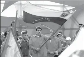  ?? AP/ARIANA CUBILLOS ?? Venezuela’s President Nicolas Maduro waves the Venezuelan flag during a rally Thursday in Caracas.