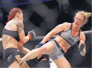  ?? JOHN LOCHER/ASSOCIATED PRESS ?? Holly Holm lands a kick on Cristiane “Cyborg” Justino, left, during their UFC 219 main event bout Saturday. Cyborg, however, landed the harder, cleaner kicks in winning the decision.