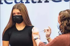  ?? Joseph Prezioso / AFP / TNS ?? A health worker administer­s a dose of COVID vaccine during a vaccinatio­n clinic for children 12 to 15 years old at Hartford Hospital in Hartford on Jan. 6.