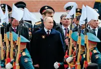  ?? — AFP ?? Russia’s President Vladimir Putin and foreign leaders lay flowers at the Tomb of the Unknown Soldier by the Kremlin wall after the Victory Day military parade in central Moscow on Thursday.