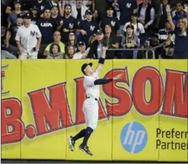  ?? FRANK FRANKLIN II - THE ASSOCIATED PRESS ?? New York Yankees right fielder Aaron Judge attempts to catch a ball hit by Cincinnati Reds’ Billy Hamilton that went for an RBI double during the eighth inning Tuesday in New York.