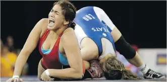  ?? GREGORY BULL/ THE ASSOCIATED PRESS ?? Venezuela’s Maria Acosta yells as she battles Canada’s Dori Yeats in the women’s 69kg freestyle wrestling event at the Pan Am Games in Mississaug­a, Ont. Yeats won the gold medal.