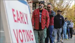  ?? JOHN SPINK/JOHN.SPINK@AJC.COM ?? Early voters wait in line at the Joan P. Garner Library in Atlanta to cast ballots on Nov. 4 in Georgia’s midterm elections. Georgia’s voter turnout of 52% was the highest of any state in the South in the midterms.