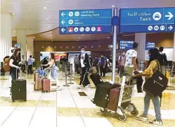  ?? Clint Egbert/Gulf News ?? ■ Passengers in the arrivals area of Dubai airport’s Terminal 3.