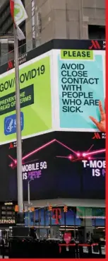  ??  ?? A message about protecting yourself from the coronaviru­s is seen on an electronic billboard in a nearly empty Times Square in Manhattan in New York City, USA