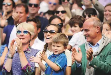  ?? AP ?? ■ Jelena Djokovic, wife of Novak Djokovic, and their son, applaud after the men’s singles final at the Wimbledon Tennis Championsh­ips in London on Sunday.