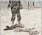  ??  ?? An Afghan National Directorat­e for Security inspects the bombing site in Kandahar AP