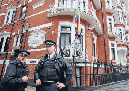  ?? Photos: REUTERS ?? Three years on, British police continue to patrol outside the Ecuadorian embassy where Julian Assange has taken refuge.