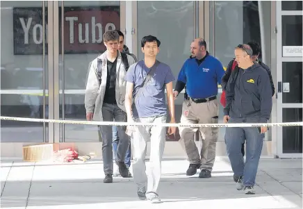  ?? Picture / AP ?? Shocked staff are escorted out of the YouTube headquarte­rs in San Bruno, California, after Wednesday’s shooting.