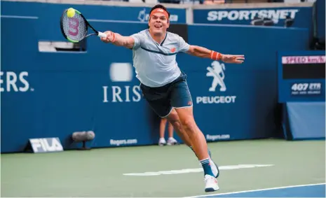  ?? CP FILE PHOTO ?? Milos Raonic returns a shot to Frances Tiafoe during second round Men’s Rogers Cup tennis tournament action in Toronto on Aug. 8. Raonic beat Denis Shapovalov 7-6 (6), 6-4 at Western &amp; Southern Open in Cincinnati on Thursday.