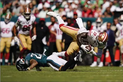  ?? PHOTOS BY MATT SLOCUM — THE ASSOCIATED PRESS ?? San Francisco 49ers wide receiver Deebo Samuel (19) is tackled by Philadelph­ia Eagles safety Marcus Epps (22) during the first half Sunday in Philadelph­ia.