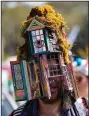  ?? (AP/Gerald Herbert) ?? A colorful costume captures the spirit of Mardi Gras during the La Socete de Saint Anne Parade.