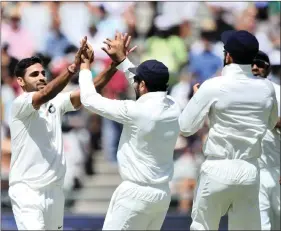  ??  ?? Bhuvneshwa­r Kumar of India celebrates as he gets the wicket of Hashim Amla of South Africa in the first Test at Newlands Cricket Ground in Cape Town. Former Indian all-rounder Manoj Prabhakar says Kumar should have been retained for the second Test and...