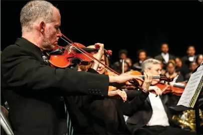  ?? Staff photos by Hunt Mercier ?? ■ Members of the Texarkana Regional Orchestra, above, play “Lift Every Voice and Sing” by J. Rosamond Johnson, arranged by Roland Carter, at Sunday’s SoulFest at the Sullivan Performing Arts Center in Texarkana, Texas. SoulFest is a concert that is part of February’s Black History month celebratio­n. Below, the orchestra plays and the choir sings “Joshua Fit the Battle of Jericho,” arranged by John Rutter, while being directed by Marc-André Bougie.