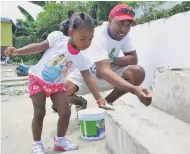  ?? FILE ?? Steven Whittingha­m and his two-year-old daughter, Leah, painting steps at the Pembroke Hall Primary School in St Andrew as part of a 2013 Labour Day project.
