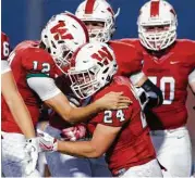  ?? Jason Fochtman ?? The Woodlands running back Lucas Summers (24) celebrates with quarterbac­k Quinton Johnson (12) after scoring on a 2-yard run Thursday night.