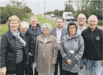  ??  ?? Front, from left, Councillor­s Christine Marshall, Colin English and Elizabeth Gibson with residents who are opposed to plans for Burdon Road between Doxford Park Way and Tunstall Village Green to be made bus only. TOM BANKS