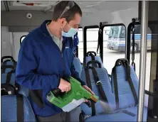  ?? SUBMITTED ?? Laketran maintenanc­e team member John Trunck sanitizes one of the transit agency’s vehicles at the company’s headquarte­rs in Painesvill­e Township. Laketran recently joined OPTA in launching “Ride Easy Ohio” to heighten safety protocols.