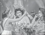  ?? AFP ?? Caroline Jurie (left) removes the crown from 2021 Mrs Sri Lanka winner Pushpika de Silva’s head in Colombo.