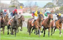  ?? ?? Callsign Mav (yellow colours) drives between I Am Superman (left) and Tuvalu to take out the Group 1 A$1 million Sir Rupert Clarke Stakes at Caulfield last Saturday. Photo / Supplied