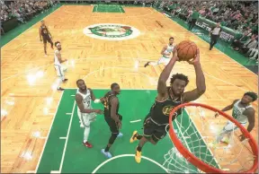  ?? The Associated Press ?? Golden State Warriors forward Andrew Wiggins goes for a dunk against the Boston Celtics during Game 3 of the NBA Finals, June 8, in Boston.