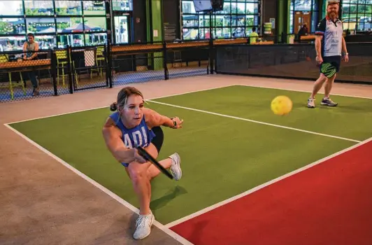  ?? Photos by Billy Calzada / Staff photograph­er ?? Kennessey Hartley returns a shot during a pickleball match at Chicken N Pickle while visiting San Antonio. The Florida resident calls the game “addictive.”