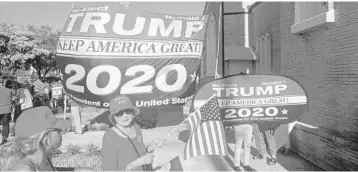  ?? DAN SWEENEY/SUN SENTINEL ?? Trump supporters wave signs and banners outside the St. Catherine Greek Orthodox Church in West Palm Beach.