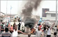  ?? PICTURE: REUTERS ?? Residents chant slogans against Congolese President Joseph Kabila as UN peacekeepe­rs patrol the streets of Kinshasa in December. The world body has extended sanctions against those found to be acting against its peacekeepe­rs and other personnel in the...