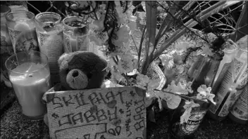  ?? Jennifer Sinco Kelleher
AP Photo/ ?? In this April 28 photo a stuffed bear is among the items left at a street memorial where Honolulu Police shot and killed 16-year-old Iremamber Sykap, whose nickname was Baby, during a car chase on Kalakaua Ave., in Honolulu.