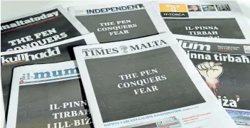  ?? AFP/GETTY IMAGES ?? Malta’s seven national newspapers ran black front pages that read, in English and Maltese, “The Pen Conquers Fear” on Sunday as a common act of defiance following the assassinat­ion of blogger Daphne Caruana Galizia on Oct. 16.