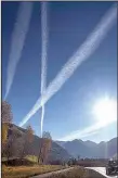  ?? The Washington Post/BONNIE JO MOUNT ?? Contrails stretch above Telluride, Colo., along the San Juan Skyway Scenic Byway, a picturesqu­e road through Colorado.