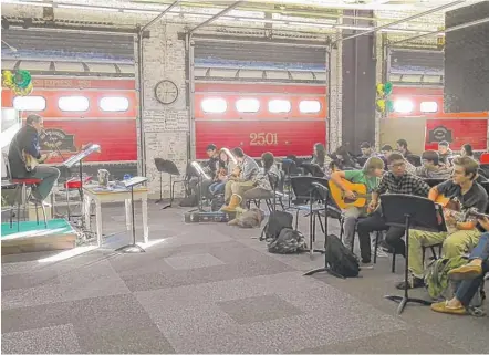  ?? | PHOTOS BY PETER HOLDERNESS/SUN-TIMES ?? Music teacher Joe Sweet leads a guitar class in Lane Tech’s Studio 2501, which used to be the high school’s auto shop space.