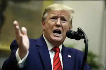  ?? EVAN VUCCI — THE ASSOCIATED PRESS ?? President Donald Trump answers questions from reporters during an event on “transparen­cy in Federal guidance and enforcemen­t” in the Roosevelt Room of the White House, Wednesday in Washington.