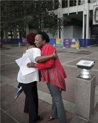  ?? ?? Pamela Moses seen hugging Lemichael Wilson outside City Hall during a May Day rally in 2019. Photograph: Jim Weber/AP