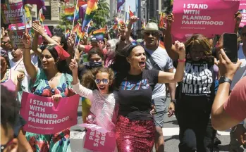  ?? CAITLIN OCHS/THE NEW YORK TIMES ?? Revelers on Sunday join the Planned Parenthood section of the New York City Pride March.